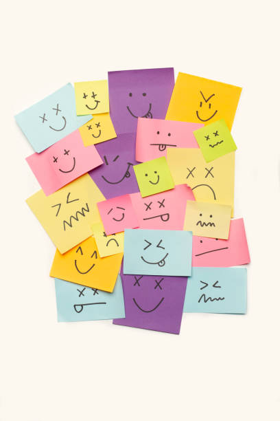 istock Colored paper notes with drawings of different face emotions on a white background 1756172020