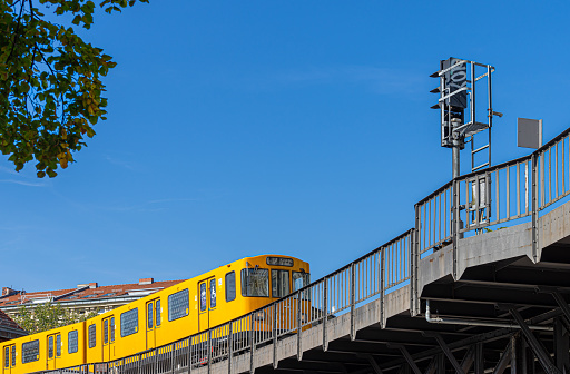 Germany, Berlin, September 25, 2023 - Berlin U-Bahn train passing a bridge, Berlin Kreuzberg