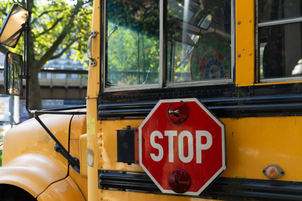 istock Side view of yellow school bus with stop sign 1756183770