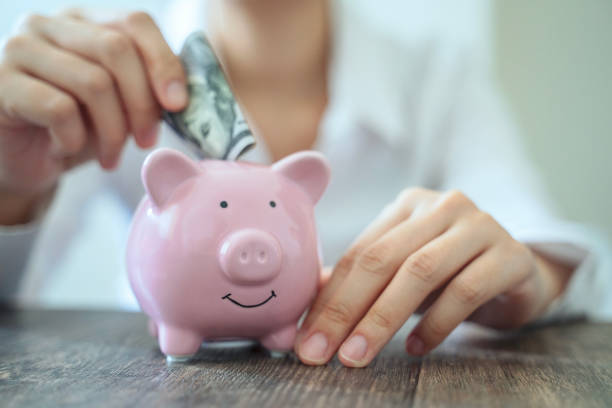 istock Holding piggy bank 1756186110