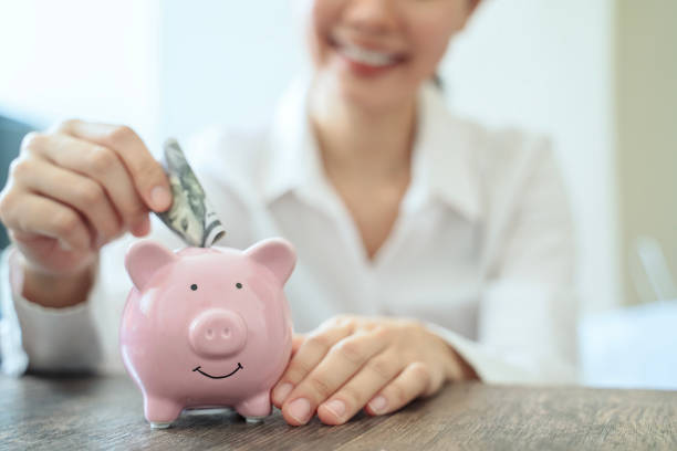 istock Holding piggy bank 1756186655