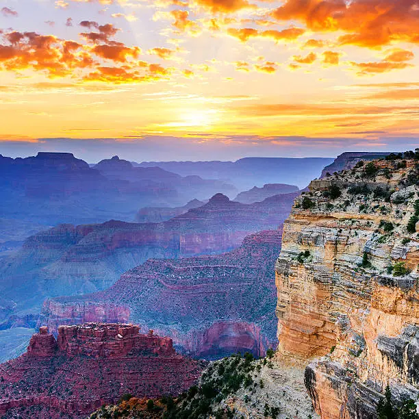 Photo of The Grand Canyon in hues of blue and purple at sunset