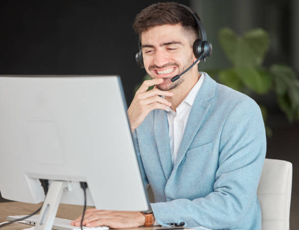 istock Man, headset and smile while looking at screen in office, talking and customer care for telemarketing. Person, consultant or operator with technology for business, e commerce or management of clients 1756200989