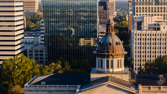 Dawn in Downtown Columbia, SC: The South Carolina State House stands in stark contrast to towering skyscrapers.