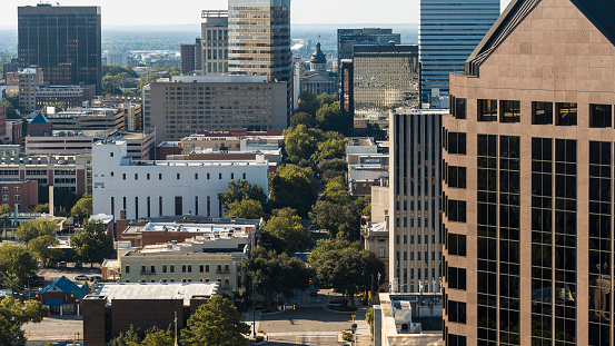 Hotels and office buildings towering above Columbia Downtown cityscape in the morning. South Carolina State House visible in the center of Main Street. View from Downtown Columbia, SC