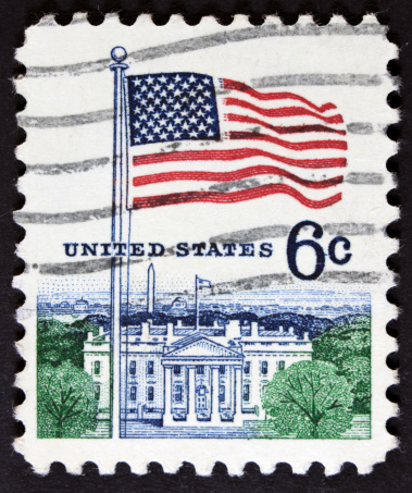 1960's postage stamp of the White House and flag.
