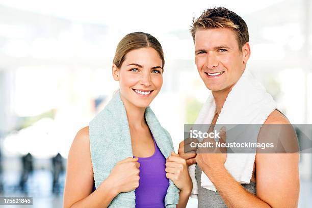 Young Couple With Towels Around Neck Smiling In Gym Stock Photo - Download Image Now