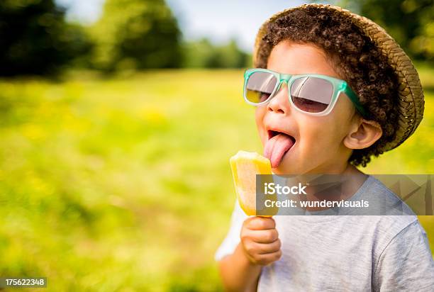 Boy In Sunglasses And Hat Eating Popsicle Outdoors Stock Photo - Download Image Now - Child, Summer, Flavored Ice