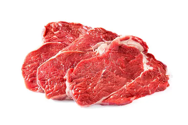 Three chuck steaks on white background