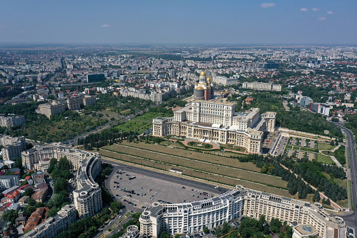 The Palace of the Parliament is the seat of the Parliament of Romania. The Palace of the Parliament is one of the heaviest buildings in the world, constructed over a period of 13 years (1984–1997). The image was captured during summer season.