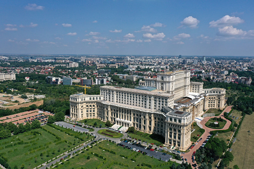 The Palace of the Parliament is the seat of the Parliament of Romania. The Palace of the Parliament is one of the heaviest buildings in the world, constructed over a period of 13 years (1984–1997). The image was captured during summer season.