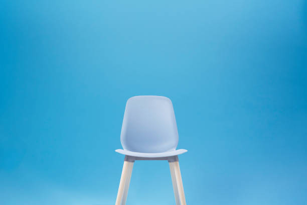 Blue classic chair on the blue backdrop for Chroma Key technique in the photo shooting studio for interview or filmmaking