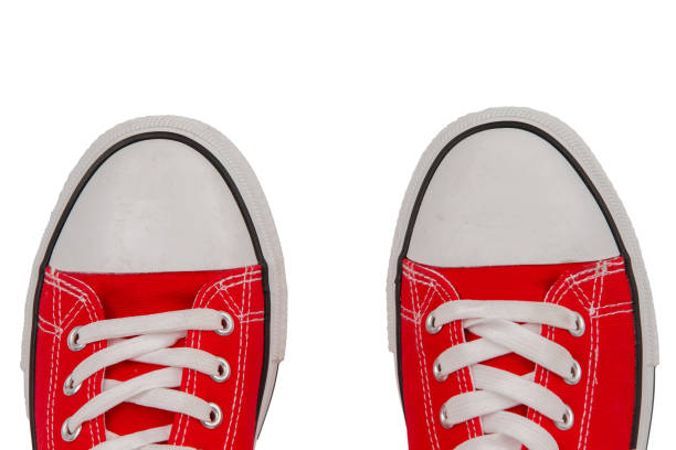 istock Red sneakers close-up on a white background, top view. 1756249655