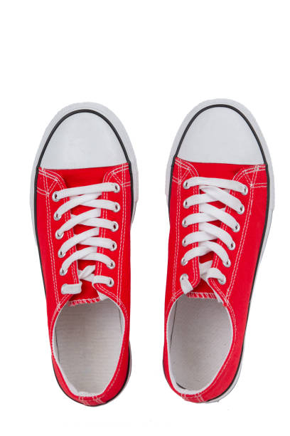 istock Red sneakers close-up on a white background, top view. 1756250195