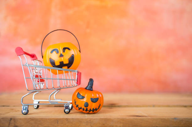 istock Halloween pumpkin lantern in shopping cart with space on blurred background 1756258411