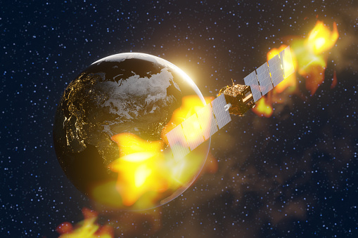 Satellite orbiting the planet Earth in the starry outer space is on fire. Illustration of the concept of damaged or retired space stations and space debris