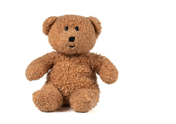This image features an old, yet cute teddy bear wearing a gray scarf, lying on a white background. The bear shows signs of wear, emphasizing its history and beloved character. Concept for themes such as childhood memories, comfort, security, and nostalgia. Ideal for advertisements, articles about toys, nursery decoration, and blogs about childhood and memories