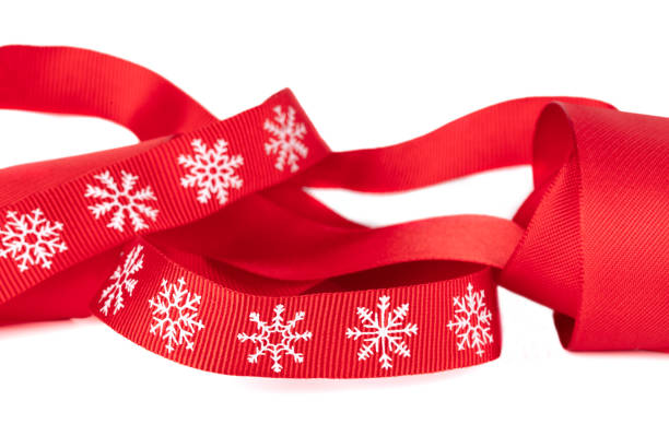 Silver ribbon and snowflake border on blue paper that can be used as a Christmas or winter background for scrapbooking, cards, or invitations