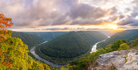 Vibrant sunrise over Grandview in New River Gorge National Park during the fall season in the Appalachian Mountains of West Virginia, USA.