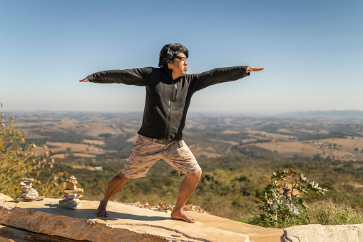 Mature man practicing yoga in nature