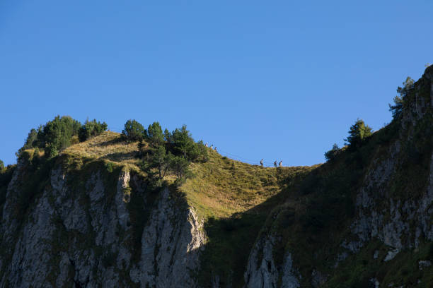 People hiking in the alpine mountains in Stoos, Schwyz, Switzerland