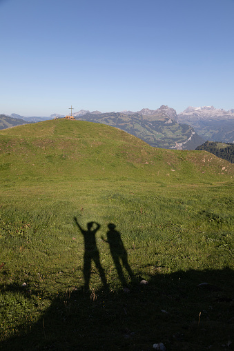 Shadow of a couple taking a self portrait in the Alps, Stoos, Schwyz, Switzerland.