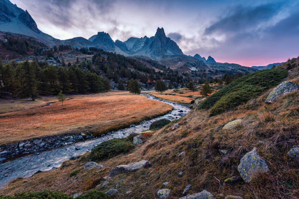 istock Sunset over Claree Valley with Main De Crepin peak and river flow through in larch forest during autumn at French Alps, France 1756295390