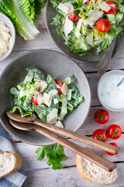 istock Green salad with tomatoes, bread and parmesan cheese 1756318284