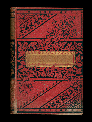 Antique red hardcover book with floral design.