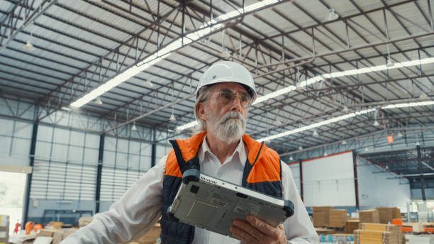istock Professional male industrial engineers use tablet while standing in manufacturing factory. Working in manufacturing plant or production plant. 1756344197