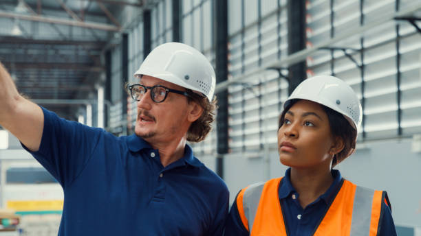 istock Professional male industrial engineers talk with factory worker while using tablet in manufacturing factory. Working in manufacturing plant or production plant. 1756344747
