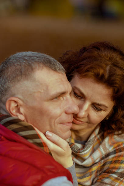 Hello autumn. relaxed modern boyfriend and girlfriend in the park embracing.