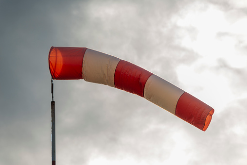 A bright orange wind indication windsock at an airport, Pretoria, South Africa