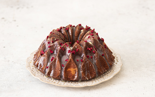Chocolate bundt cake with glaze decorated with berries