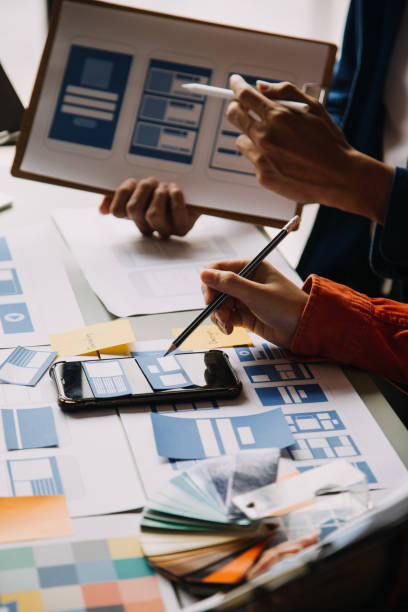 istock Close up ux developer and ui designer use augmented reality brainstorming about mobile app interface wireframe design on desk at modern office.Creative digital development agency 1756380661