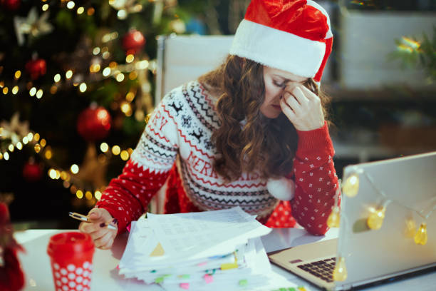 istock business woman in green office with Christmas tree working 1756401906