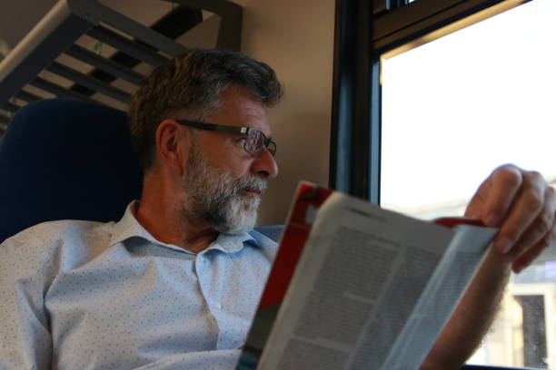 istock Mature man read newspaper in public transport 1756407864