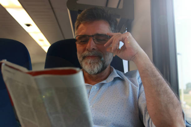 istock Mature man read newspaper in public transport 1756407869