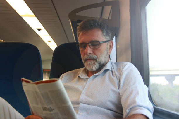istock Mature man read newspaper in public transport 1756407899