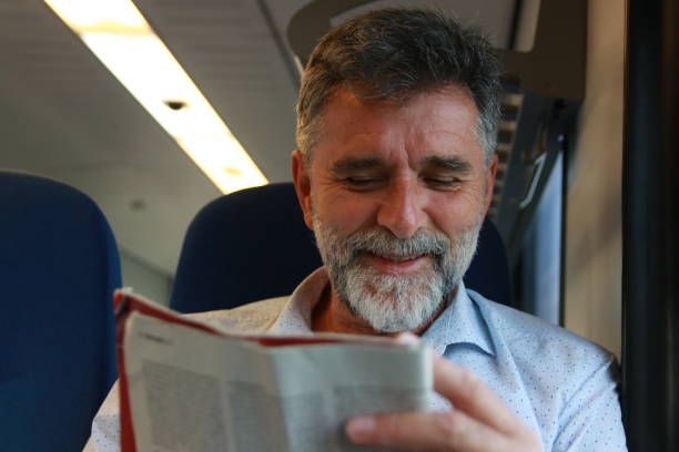 istock Mature man read newspaper in public transport 1756408427