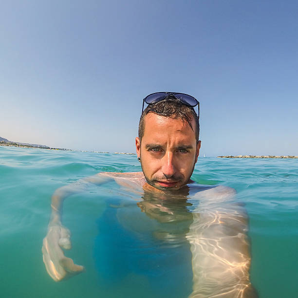 istock Young man self portrait in the water sea 175641222