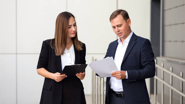 istock Young businesswoman and businessman discuss documents 1756418677