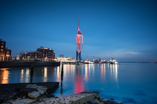 A picture of portsmouth harbour at night showing quays and the tower