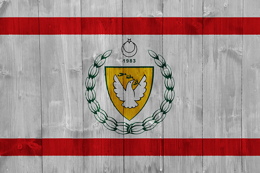 Flag and coat of arms of Turkish Republic of Northern Cyprus on a textured background. Concept collage.