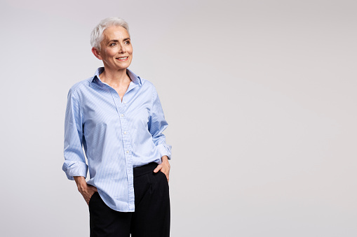 Senior woman with gray hair wearing casual clothes with a happy and cool smile on face. lucky person.