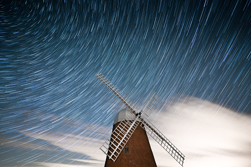 Stars trailing at night behind the iconic sussex windmill.