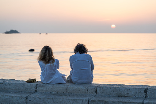 Rovinj, Croatia - October11, 2023: People watch the sunset on the waterfront and in cafes of the old town