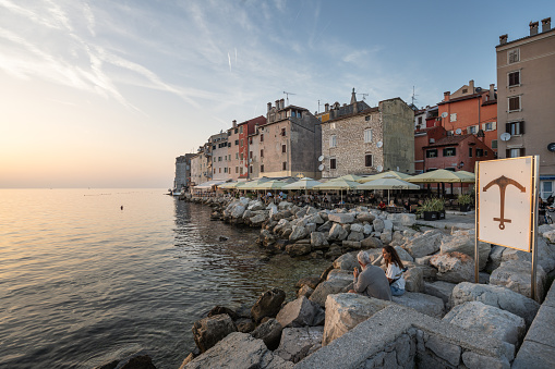 Rovinj, Croatia - October 11, 2023: People watch the sunset on the waterfront and in cafes of the old town