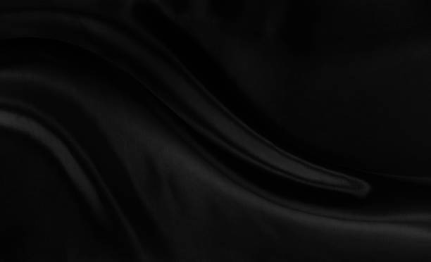 istock Black gray satin dark fabric texture luxurious shiny that is abstract silk cloth background with patterns soft waves blur beautiful. 1756459114