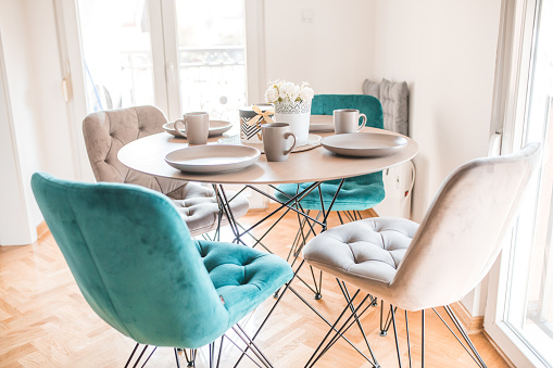 A view of a tidy, bright living room without people in the apartment, which is modernly decorated from an architectural point of view